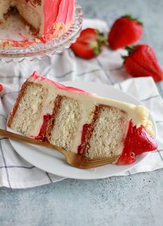 a slice of cake on a plate with strawberries