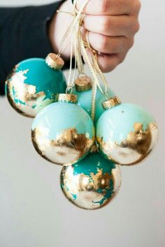 a person holding some ornaments in their hand