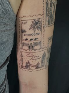 a woman with a tattoo on her arm has a stamp that says morocco and palm trees