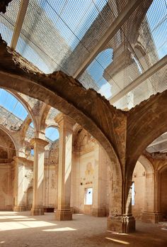 the inside of an old building with many arches