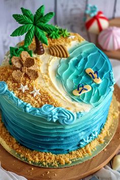 there is a cake with blue frosting and palm trees on the top, sitting on a wooden platter