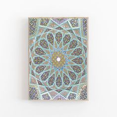 an intricately designed painting on a white wall with blue and green colors in the middle