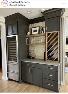 a wine rack in the middle of a kitchen with gray cabinets and silver counter tops