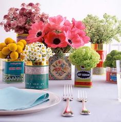 the table is set with colorful flowers and silverware