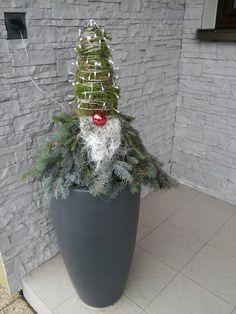 a potted plant with a fake christmas tree on top