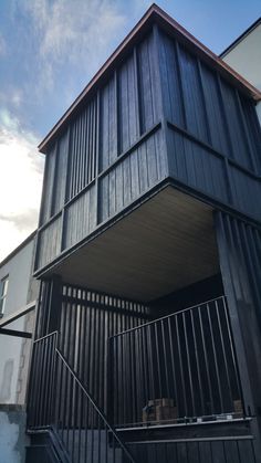 a building with stairs leading up to the top floor and second story on one side