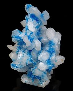 a cluster of blue and white crystals against a black background