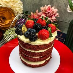 a red velvet cake topped with berries and raspberries