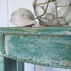 a sea shell sitting on top of a green table