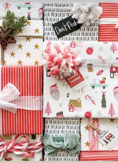 christmas wrapping with red, white and green items on top of each other next to a candy cane