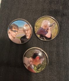 three buttons with pictures of people on them