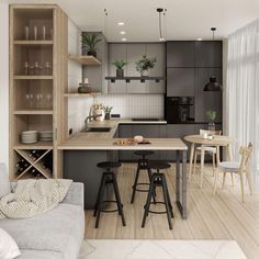 an open kitchen and dining area with wooden floors, white walls and gray cabinetry