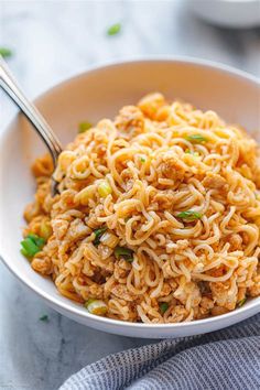 a white bowl filled with noodles on top of a table