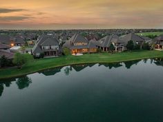 an aerial view of houses and water at dusk