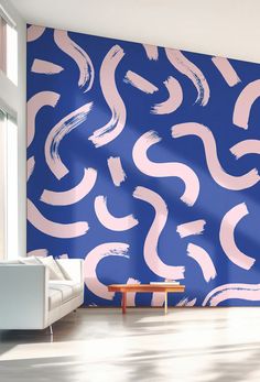 a living room with blue and pink wallpaper that has wavy lines painted on it