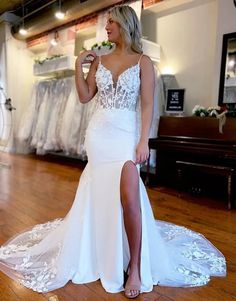 a woman in a white wedding dress standing on a wooden floor with her leg up