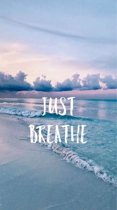 the words just breathe are written in front of an ocean beach with waves and clouds