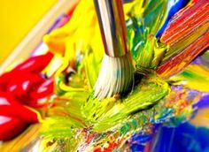 the paintbrush is being used to paint colorful paints