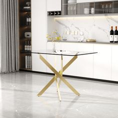 a kitchen with marble flooring and white cabinets, wine bottles on the counter top