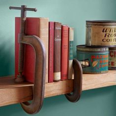 a shelf with some books on it and an old pair of scissors hanging from the top