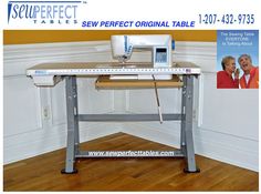 a sewing machine sitting on top of a wooden table next to a poster with the words sew perfect