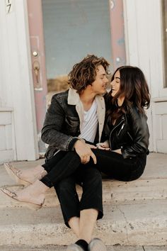 a man and woman are sitting on the steps