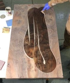 a man is working on a wooden table