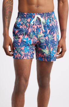 Lightweight and stretchy, these pool-to-party swim trunks feature plenty of handy pockets plus interior compression shorts for easy, supportive comfort. 5 1/2" inseam; 23 1/2" leg opening Elastic/drawstring waist Side-seam pockets; back welt pocket Interior compression shorts 91% polyester, 9% spandex Machine wash, tumble dry Imported Tropical Swim Trunks With Built-in Shorts For Poolside, Pink Swim Trunks With Built-in Shorts For Beach Season, Hawaiian Style Swim Trunks With Built-in Shorts For Poolside, Fitted Tropical Swim Trunks For Pool, Fitted Summer Swim Trunks For Water Sports, Fitted Swim Trunks For Water Sports In Summer, Summer Beach Swim Trunks With Short Inseam, Fitted Hawaiian Style Bottoms For Poolside, Short Inseam Swim Trunks For Summer Beach