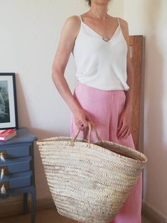 a woman holding a basket in her hands