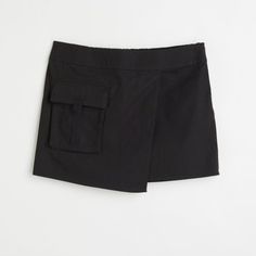 Size Xs, Skirt In A Cotton Weave. Regular Waist With Covered Elastication At The Back And A Sewn-In Wrapover At The Front. Concealed Zip In One Side And A Patch Front Pocket With A Flap. New With Tags Casual Skirt With Built-in Shorts For Work, Chic Black Cargo Skirt With Side Pockets, Black Short Cargo Skirt For Spring, Black Skort (shorts With Skirt Shape), Black Cotton Short Mini Skirt, Short Black Cotton Skort, Black Spring Skort With Side Pockets, H&m Mini Length Bottoms For Summer, H&m Summer Skort Short Length