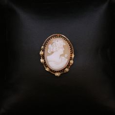 A timeless treasure! This elegant vintage cameo brooch doubles as a pendant, offering versatility and style.   Crafted in luxurious 14K gold, with a beautiful filigree and leaf design. The 1" x 3/4" cameo is carved from a conch shell and has a beautifully sculpted woman of antiquity. The handmade carving is a true testament to the artisan's skill and precision.   This piece is not just jewelry; it's a piece of art and history.    (Brooch/Pendant only - chain not included) Luxury Cameo Brooch, Design Motifs, Custom Wedding Band, Buy Jewellery Online, Vintage Cameo, Cameo Brooch, Conch Shell, Timeless Treasures, Vintage Pins