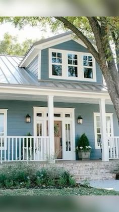 a blue gray house with white trim on the front door and windows, in google search