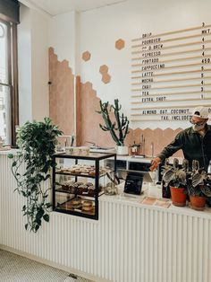 a man standing behind a counter filled with food