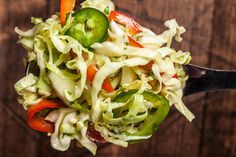 a close up of a salad on a spoon