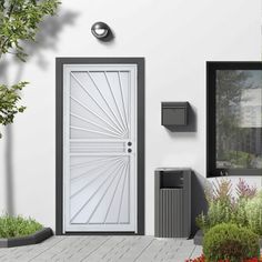 a white door and some plants on the side of a building