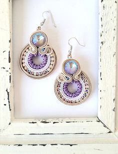 Sparkling soutache earrings, with premium quality glass cabochons, surrounded with soutache cord and beautiful rhinestones. The earrings are hand sewn and one of a kind. The earrings are very elegant, and perfect for a special occassion, but also wearable on a normal day, if you want to feel like a queen! The backing is cream  ultra suede. Length with hook:6 cm,  width: 3 cm. You will receive the earrings in a gift bag, shipped in a bubble envelope, with track and trace code. For more earrings p Soutache Earrings, Sparkle Earrings, Bubble Envelopes, Stunning Necklace, Chandelier Earrings, Bridal Earrings, Handmade Earrings, Bracelet Making, Statement Earrings