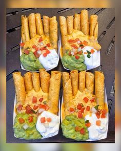 four trays filled with different types of food on top of each other, including tortilla shells and guacamole