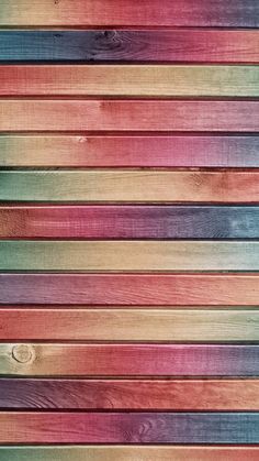 multicolored wood planks are arranged in a horizontal pattern, forming a rainbow - hued background