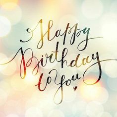 the words happy birthday to you are written in cursive writing on a blurry background