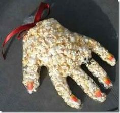 a hand made out of rice krispy treats with candy canes on the palm