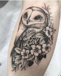 an owl with flowers and leaves on the thigh is shown in black and grey ink