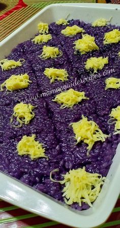 a white dish filled with purple food and cheese