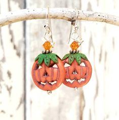 "These adorable little jack o lantern pumpkins will definitely bring you some Halloween cheer. These tangerine orange carved howlite stones are accented with genuine copper hand patinaed green bead caps on top that resemble the stem of the pumpkin. Atop the green leaves sits a sparkly orange Swarovski crystal. They measure 1 1/2\" in length from the top of the sterling silver earwires and 5/8\" in width. **Ready to ship in 3-5 days** See more Halloween and Autumn Earrings here: See more of my je Whimsical Handmade Halloween Earrings, Fun Orange Halloween Jewelry, Fun Orange Jewelry For Halloween, Whimsical Handmade Earrings For Halloween, Novelty Orange Earrings For Halloween, Fun Orange Halloween Earrings, Fun Orange Earrings For Halloween, Orange Dangle Earrings For Halloween, Cute Orange Halloween Earrings