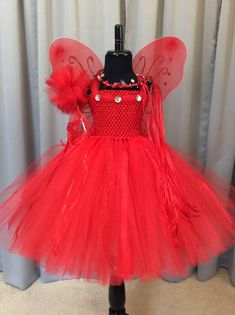 Fuzzy Duckling Design dresses ~ handcrafted for the little princess in your life. Our beautiful dresses feature a stretchy, crocheted bodice that is fully lined for both comfort and modesty. The full skirts sparkle and shine with three layers of high quality tulle in matte, shimmer, and glitter finishes. Satin ribbons and jewels are added to make each dress something special. She'll feel like a fairy princess when wearing her matching accessories. This dress includes a matching sparkly ribbon cr Fairy Style Party Dress, Whimsical Tulle Tutu Dress For Fancy Dress, Fairy Tulle Dress For Dress-up, Fairy Style Tulle Dress For Dress-up, Red Princess Tutu Dress For Costume Party, Fairy Style Princess Dress For Fancy Dress, Fairy Style Tulle Princess Dress For Fancy Dress, Tulle Fairy Dress For Fancy Dress Occasions, Fitted Fairy Dress For Dress-up