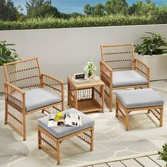 four wicker chairs and one ottoman on a patio