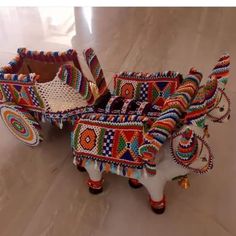 two colorfully decorated horses are sitting on the floor