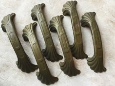 four antique style door handles on the floor