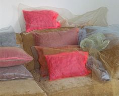 a couch with several different colored pillows on it