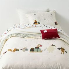 the comforter is white and has animals on it