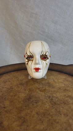 a white mask sitting on top of a wooden table